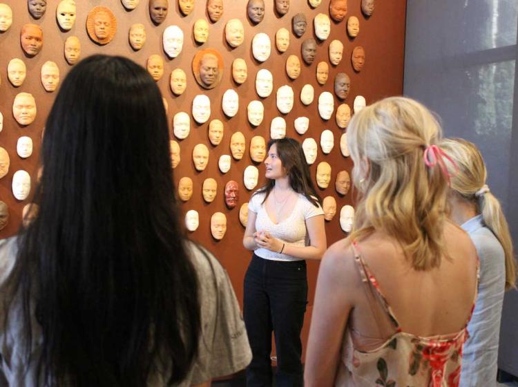 An image of a student giving a tour of the Cantor museum to two other students