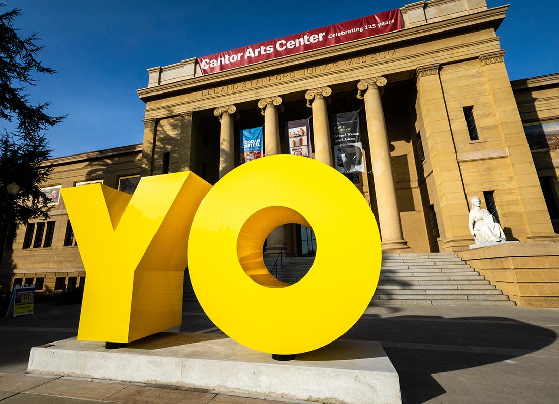 A yellow sculpture with the oversized letters Y and O