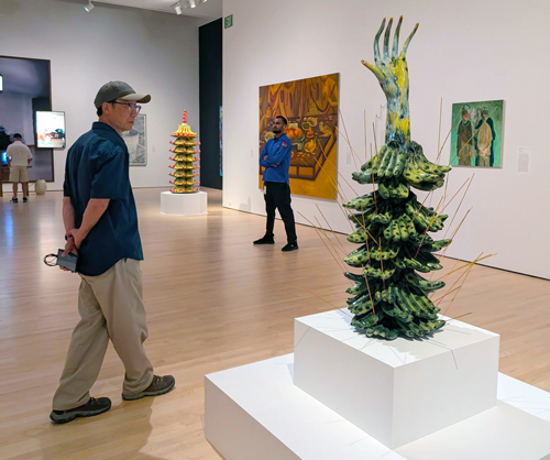 an image of a man observing a sculpture