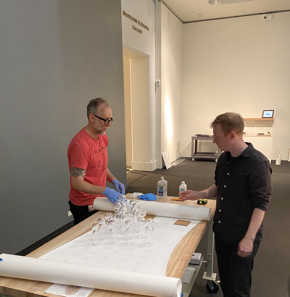 An image of two men in a gallery