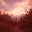 A moody, reddish landscape with a rocky path winding through sparse trees beneath a dramatic sky streaked with glowing pink and orange clouds.