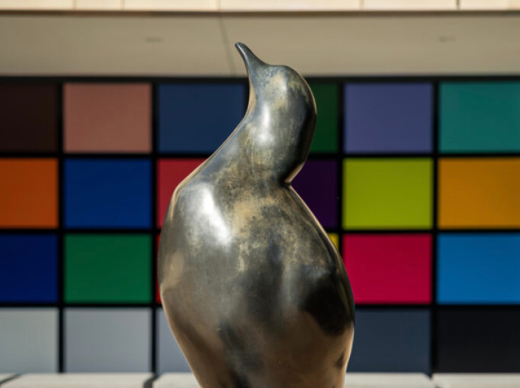 a bronze sculpture of a bird