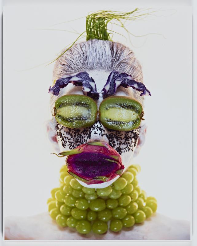 An image of an indigenous woman's face made out of fruit.