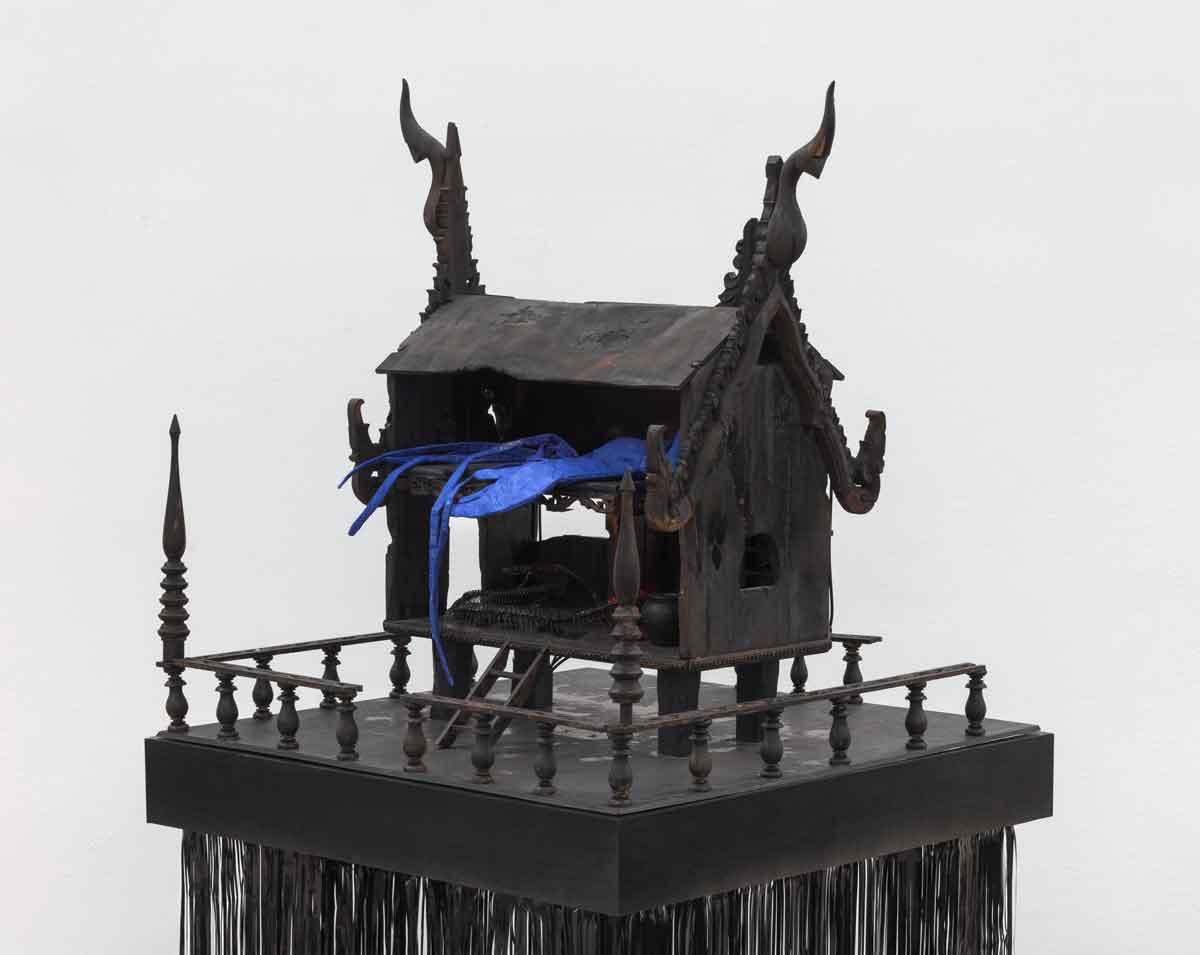 Korakrit Arunanondchai, "Shore of Security," 2022. Repurposed wooden doll house made by the artist's mother, wood, house paint, polyurethane, fabric sculpture, ceramics, snake skeleton, LED lights. 60 in. x 29 ¼ in. x 29 ¼ in. (152.4 cm x 74.3 cm x 74.3 cm). Courtesy the artist and C L E A R I N G, New York Brussels / Los Angeles. Photo: JSP Art Photography